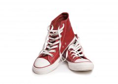 Pair of new red sneakers isolated on white background.