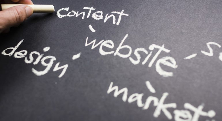 Hand pointing at Content word of Website Creation concept on chalkboard